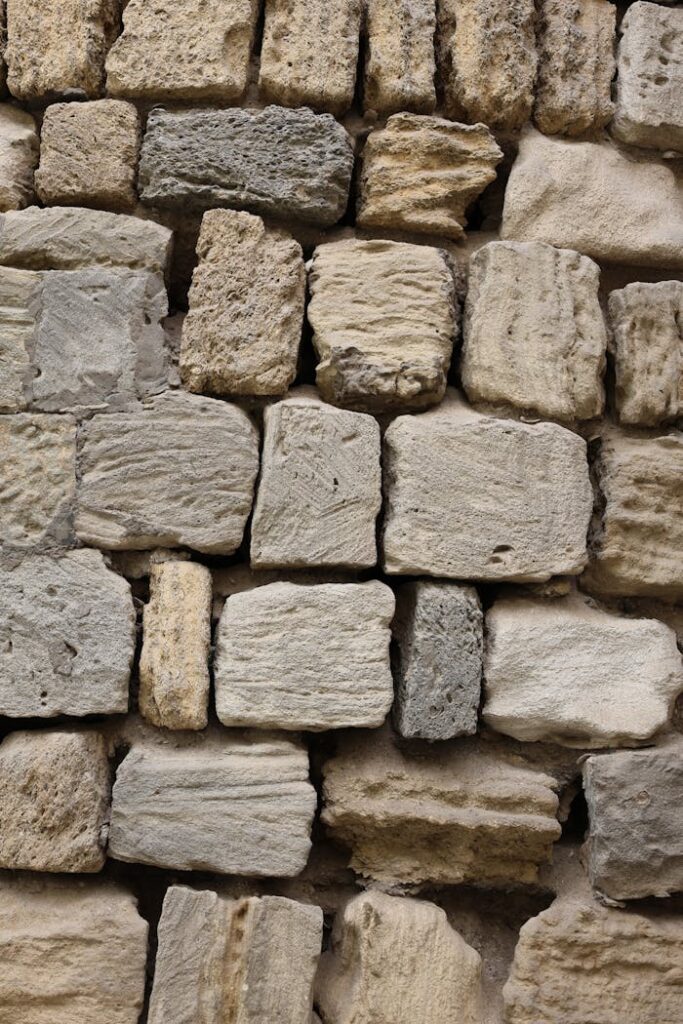 pexels photo 34309998 Detailed view of a rustic stone wall with varied textures and colors.