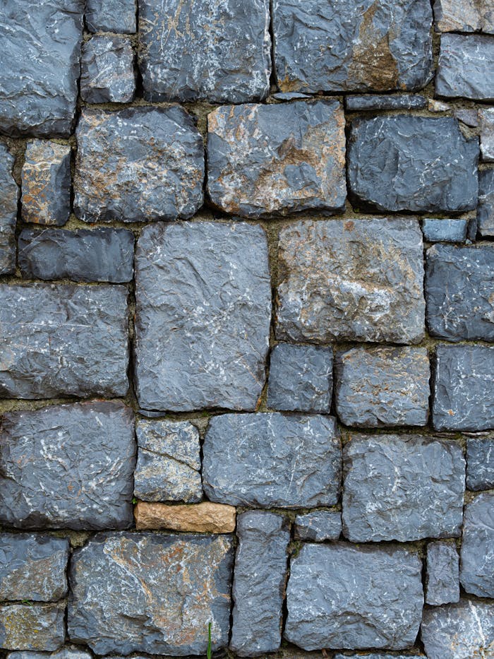 Close-up of a rustic stone wall showcasing texture and earthy tones.
